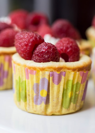 Raspberry-swirled lemon cheesecake cups filled with fresh whipped cream and raspberries are the perfect Spring treat!